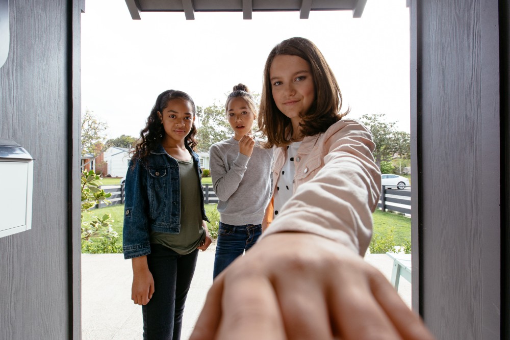 Parents politely talking to visitors at the door